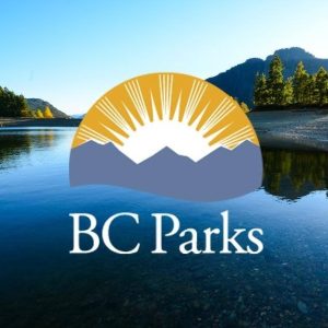 BC Parks logo overlaying a calm lake with mountain background. 
