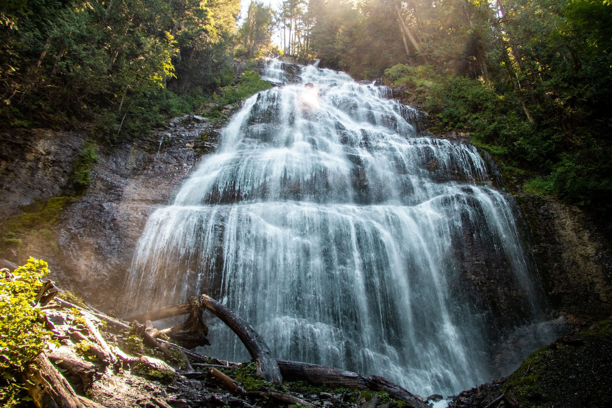 The 60-meter cascading waterfall at Bridal Veil Falls Provincial Park, creating a delicate veil-like effect over the rock face.
