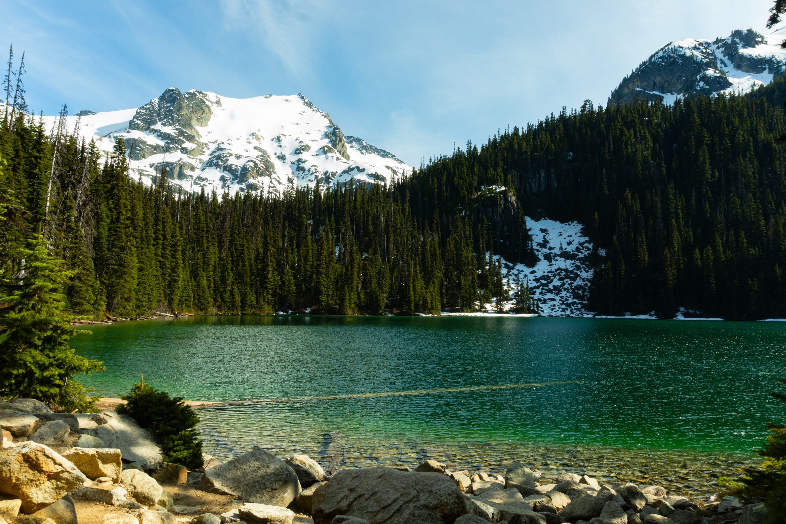 Middle Joffre lake with a snow capped mountain in the background.
