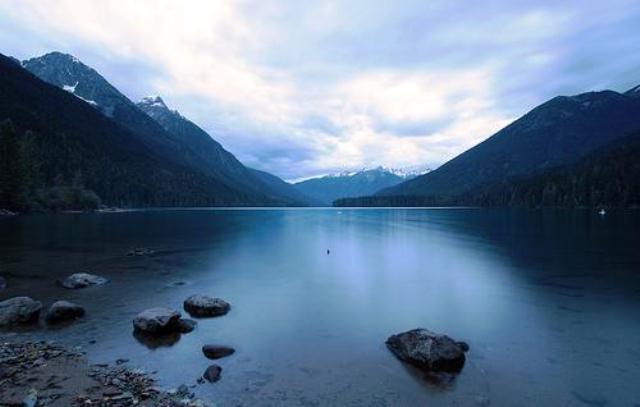 Moody, overcast sky over the tranquil waters of Birkenhead Lake in Birkenhead Lake Provincial Park, BC.