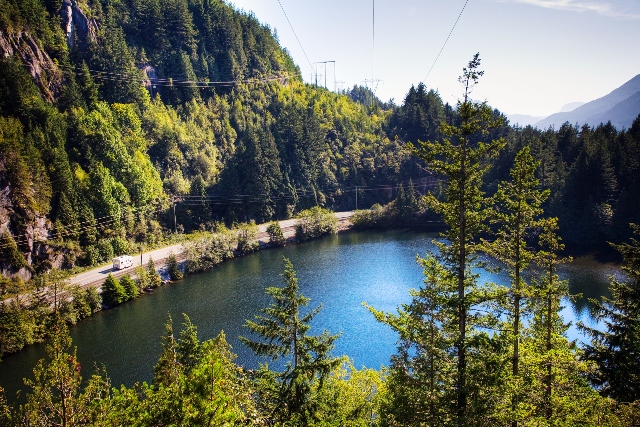 The calm waters of Browning Lake surrounded by lush forest and granite cliffs at Murrin Provincial Park.